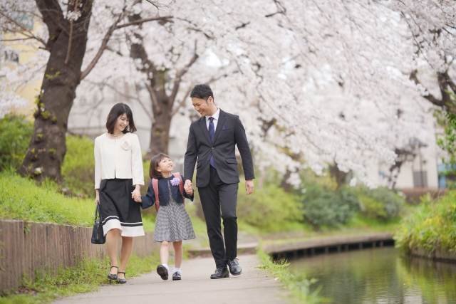 親子で桜道を歩く画像